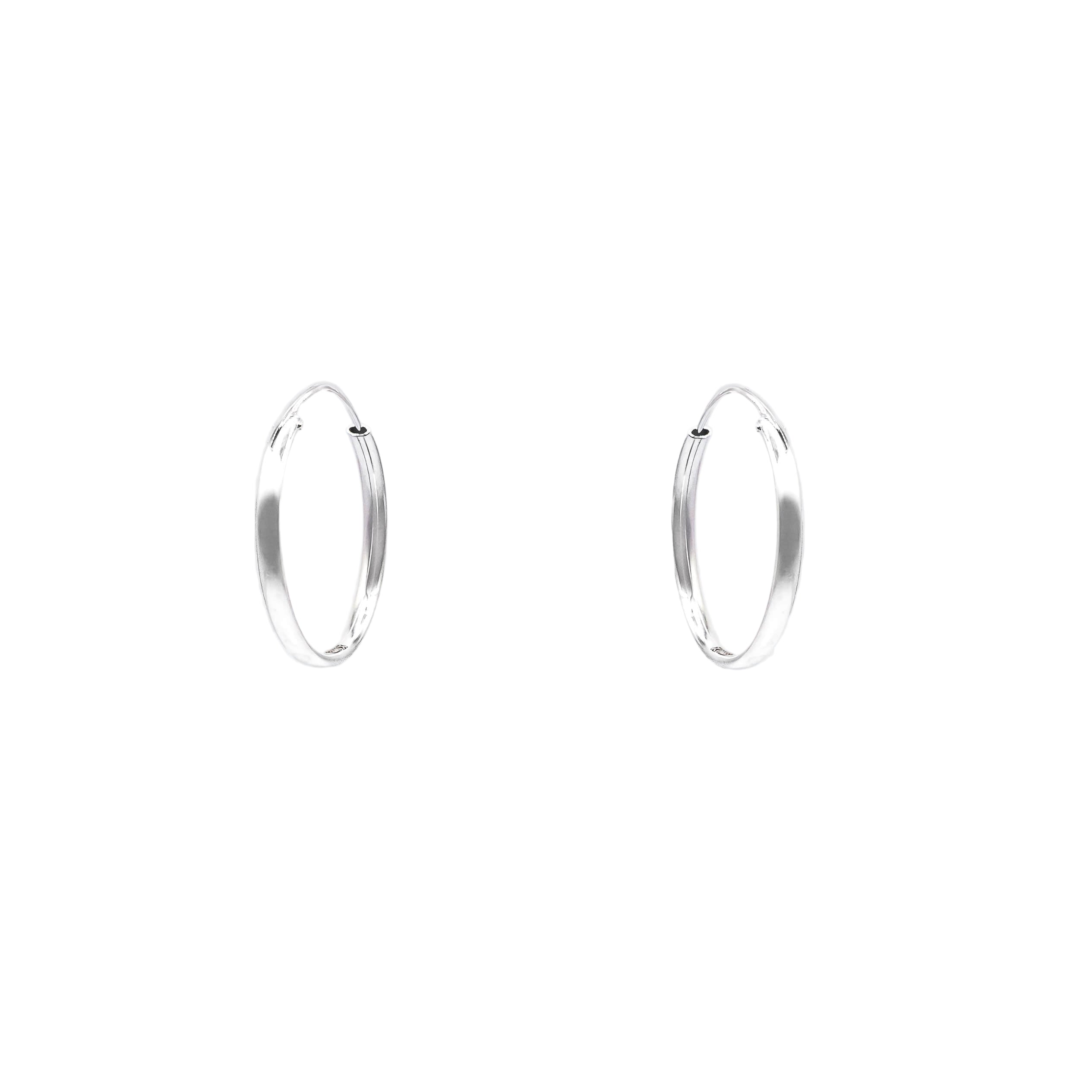 Pair of silver hoop earrings on a light gray background