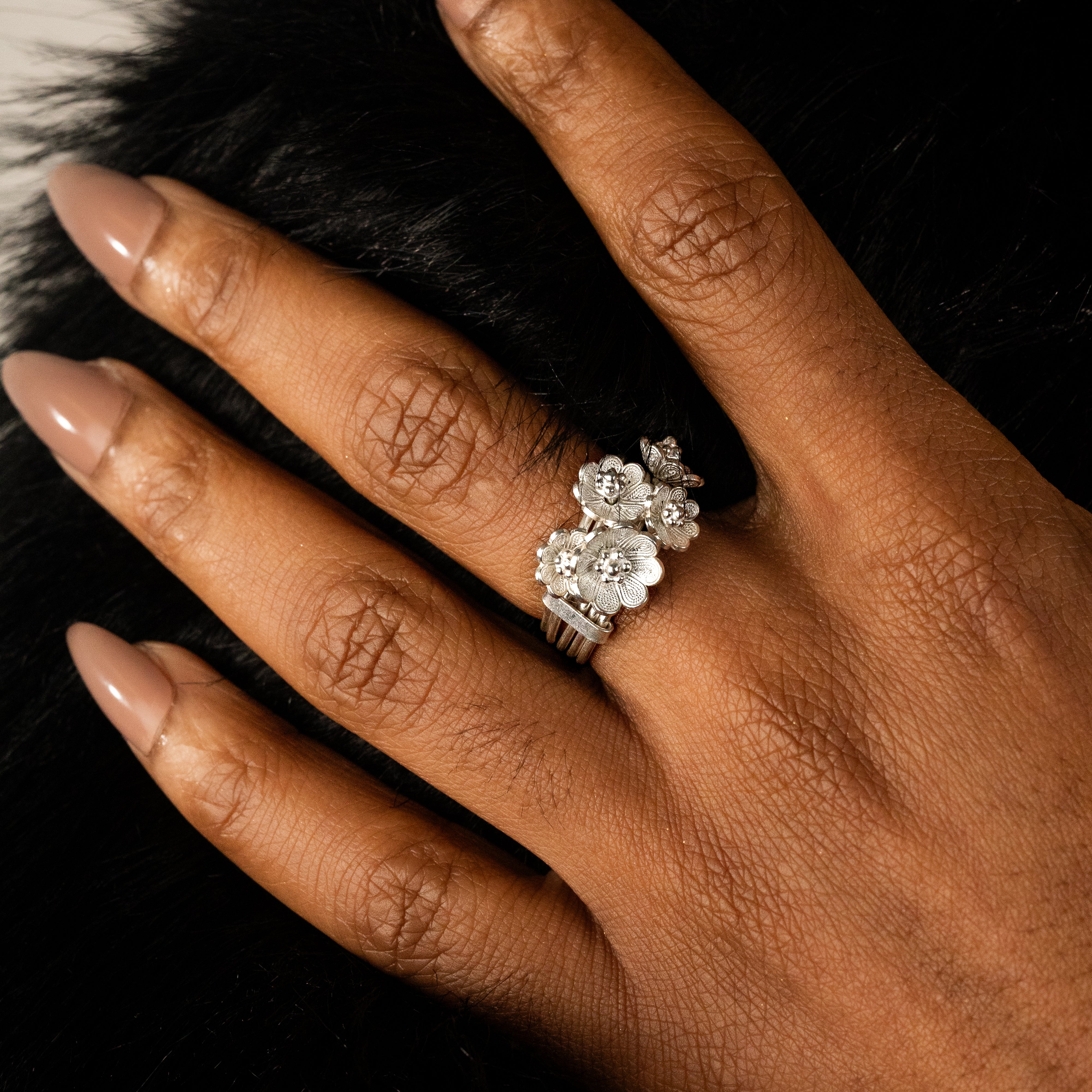 Detail shot of the ring’s ascending azalea flowers, each one sculpted in traditional filigree for a textured, handcrafted finish.
