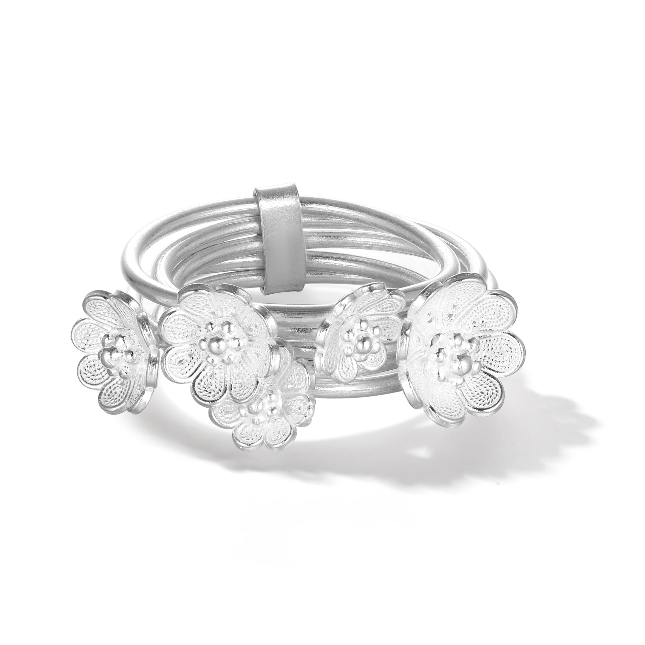 Filigree azalea blossoms in 999 silver spinning gently on the ring, offering interactive movement with refined detail.